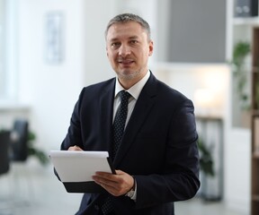 Fototapeta premium Portrait of lawyer with clipboard in office