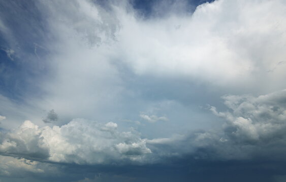 Dramatic white and grey storm clouds background in blue sky