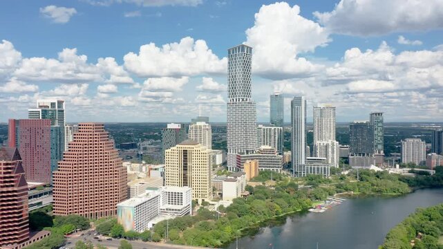 Aerial revealing shot of Austin, Texas skyline with slow camera rotating pull back, along Colorado river. Austin is the capital city of the U.S. state of Texas.
