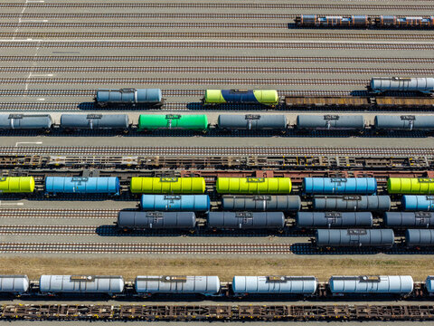 Aerial view of Emplacement Kijfhoek with colorful tank cars and freight trains parked on parallel tracks at the industrial railway marshalling yard in Zwijndrecht, Zuid-Holland, Netherlands.