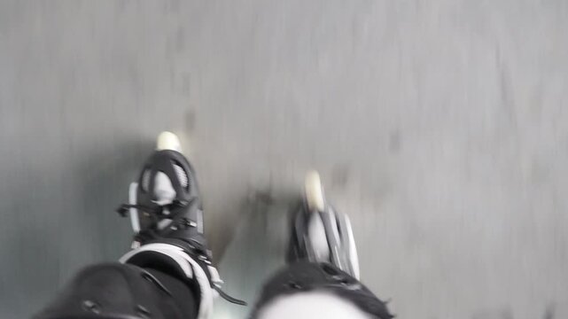 Girl roller skating having fun indoors. A girl learns to roller skate on a special area wearing a helmet and knee pads. Active sports for children