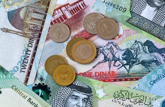 Bahraini dinar money banknotes and coins on table. Bahrain cash bills of BHD currency