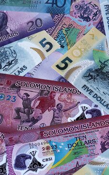 Solomon Islands dollar money bills in pile. Big amount of Solomon Islands SBD currency cash close up