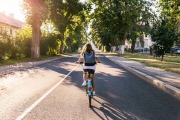 Naklejka premium Young Girl on Bike Commuting to School in Morning