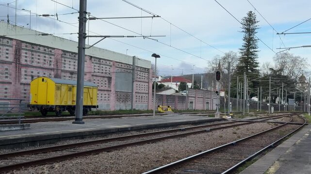 empty railway station platform with tracks and yellow wagon concept of transport, logistics, travel, banner