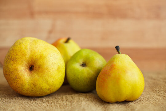 Fresh ripe organic pears on rustic burlap background with copy space