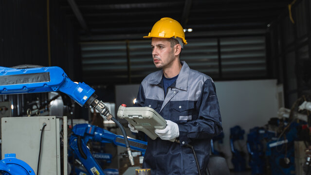 Industrial Automation Specialist evaluating production equipment Near a Blue Robotic Arm in a Production Environment Scene 306