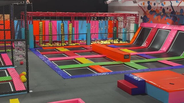 colorful indoor trampoline park with ninja park, foam pits, concept of entertainment, fitness, recreation, banner 
