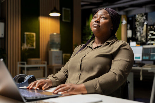 General manager engages in methodical planning after hours at the corporate office, envisioning ideas and reflecting on business outlooks to turn a challenging problem into a tactical solution.