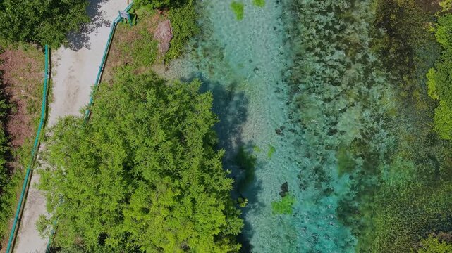 Aerial view of The Blue Eye spring with turquoise water and lush trees in Saranda, Qarku i Vlores, Albania.