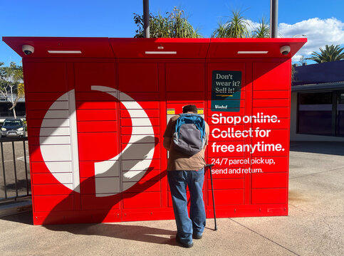 Australian man using collecting post from Australia Post 24-7 Parcel Locker 