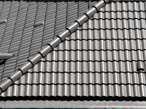 View of grey tiled roof with ridge line in Avcilar, Istanbul, Turkiye.