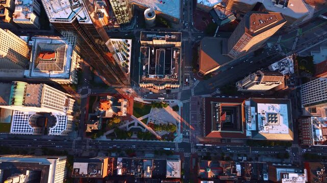 Descending over the beautiful little park area in the modern urban city. Green area in the skyscraper jungle. Copley Square in Boston, Massachusetts. Top view.