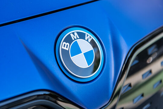 Miami, Florida, USA - December 06, 2025: BMW i4 electric liftback sedan coupe style car. Electric car BMW i4. Car BMW i4 parked outdoor. Blue electric car, logo sign view.