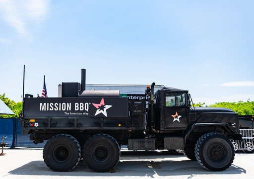 Miami, Florida, USA - May 23, 2025: AM General M35 series military truck made as MISSION BBQ catering truck, military truck for cooking. Black customized military vehicle outdoor