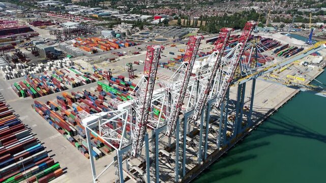 Southampton, England, United Kingdom - 15 August 2026: Aerial view of the Port of Southampton featuring large container cranes and rows of colorful shipping containers.