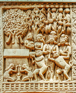 Aniconic Buddhist relief depicting devotees venerating a sacred Bodhi Tree shrine with nāga worshippers, attendants, and ritual offerings, symbolizing the Enlightenment of the Buddha, from Sanchi