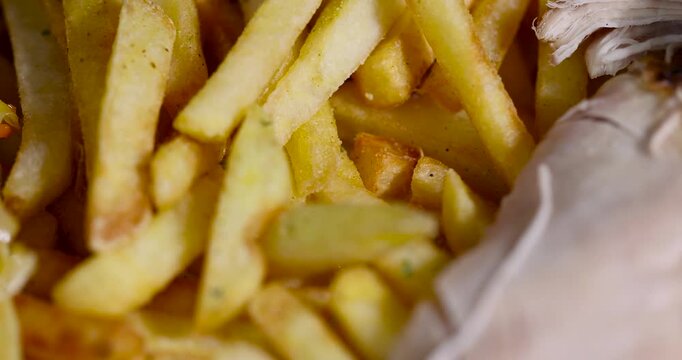 Golden potato french fries background, heap of crispy yellow french fries pieces prepared for fast food side dish meal