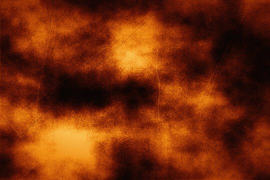 Intense fire orange abstract texture with dark shadows and scratch marks for volcanic effect.