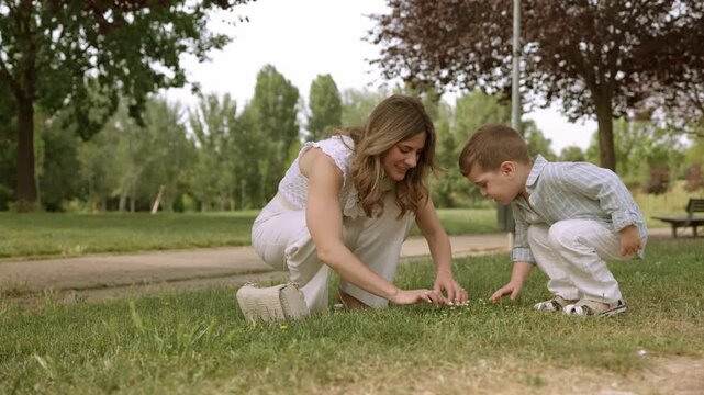 Mother and son exploring nature in a park together