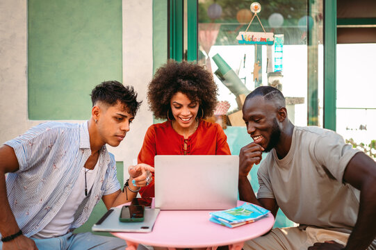 Friends enjoy their social life together while communicating online, sharing moments over a laptop