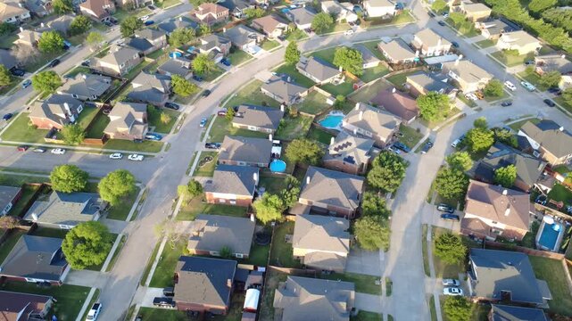 Branching residential roadways organize neighborhood blocks in Lakewood Estates. Rooftop photovoltaic arrays, turquoise splash pools, paved drives capture modern living, Little Elm, Texas