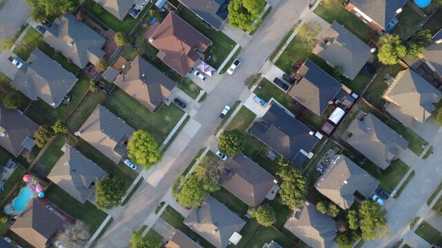 Four way street crossings unite residential lots in Lakewood Estates near Crestlake Drive. Driveway canopy tents, parked pickup trucks, composite shingles reflect active living, Little Elm, Texas
