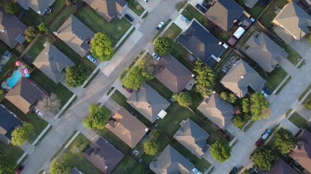 Angular intersections organize vehicular traffic through Lakewood Estates corridors. Shaded patio umbrellas, splash pools, green tree canopies enhance relaxing suburban life, Little Elm, Texas