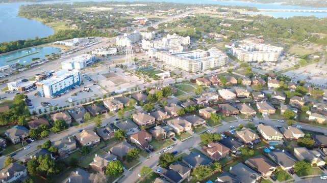Vibrant civic centers border Lakewood Estates near Little Elm Lakefront district. Municipal water towers, aquatic parks, apartment complexes illustrate modern town growth, Texas