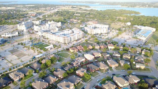 Lewisville Lake toll bridge spans shimmering waters beyond Lakewood Estates. Lakeside recreational facilities, sprawling plazas, dense rooftops display premier coastal growth, Little Elm, Texas