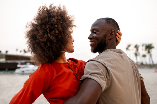 Couple sharing an intimate conversation, focusing on connection, emotional bonding on the beach