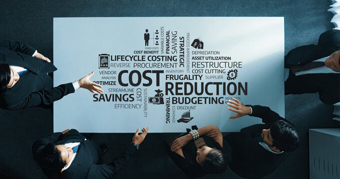A top-down view of a business meeting where professionals discuss cost reduction and budgeting strategies to enhance operational efficiency and drive savings. Amity