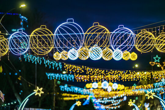 Vibrant holiday street with colorful festive lights at night