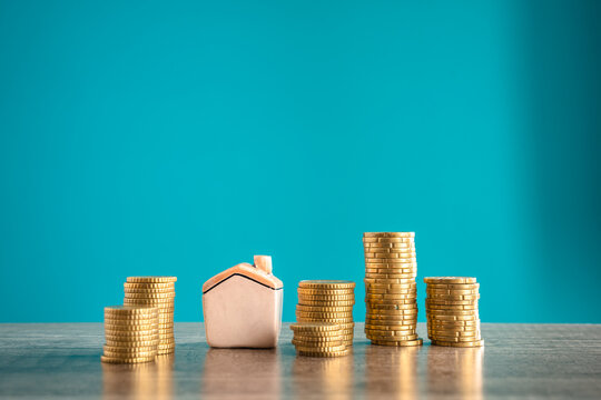 coins and a miniature house representing the market value of the property and the mortgage equivalent