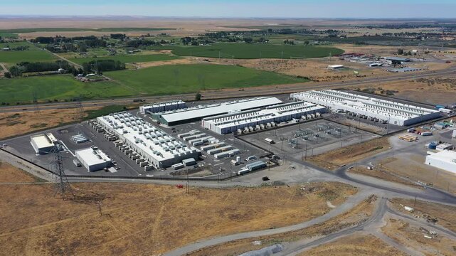 4K aerial drone footage of a hyperscale data center campus of a leading ecommerce and cloud services company near I-84 freeway and the Columbia River in Boardman, Oregon, USA with power substation