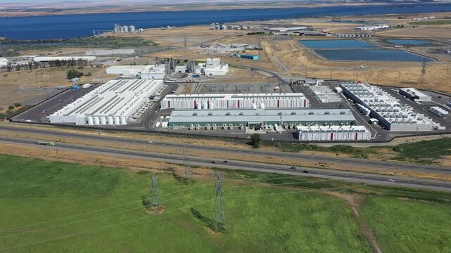4K aerial drone footage of a hyperscale data center campus of a leading ecommerce and cloud services company near I-84 freeway and the Columbia River in Boardman, Oregon, USA with power substation