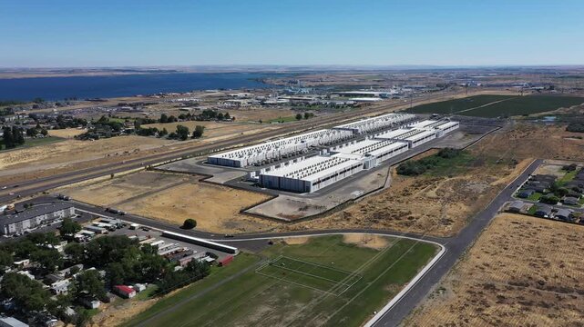 4K aerial drone footage of a hyperscale data center campus of a leading ecommerce and cloud services company near I-84 freeway and the Columbia River in Boardman, Oregon, USA with power substation