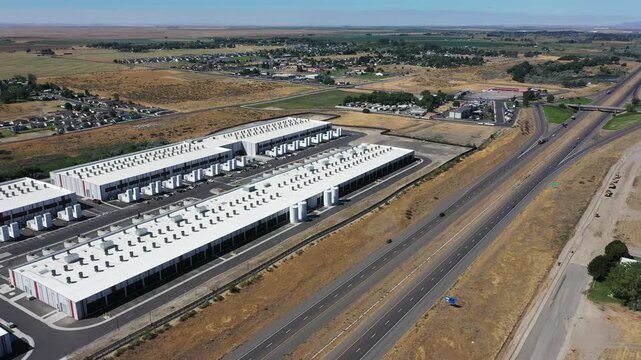 4K aerial drone footage of a hyperscale data center campus of a leading ecommerce and cloud services company near I-84 freeway and the Columbia River in Boardman, Oregon, USA with power substation