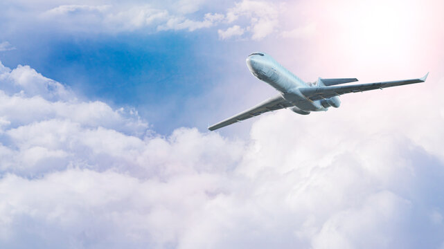 White Commercial Airplane Flying Through Soft Pastel Clouds &mdash; 3D Render