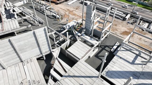 Modern Prefabricated Concrete Building Under Construction with Precast Columns Wall Panels and Hollow Core Floor Slabs, Aerial View