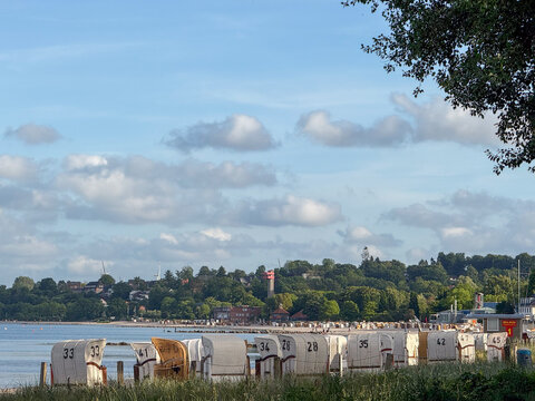 Hooded beach chairs lined up along coast in Eckernf&ouml;rde Germany