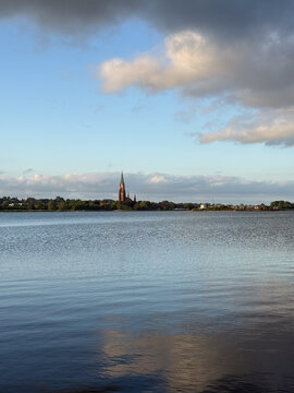 Church steeple over lake in Schleswig-Holstein, Germany