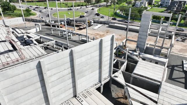 Modern Prefabricated Concrete Building Under Construction with Precast Columns Wall Panels and Hollow Core Floor Slabs, Aerial View
