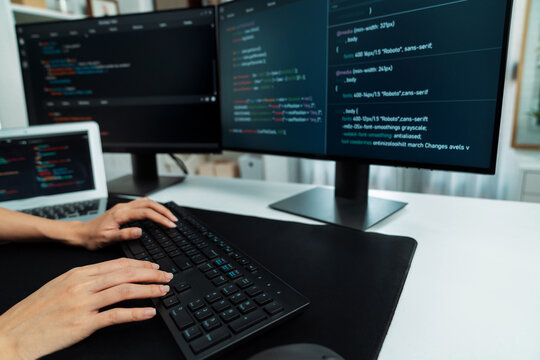 Cropped hands image of IT developer creating with typing information on pc with coding program information data website application, wearing jeans shirt surround safety analysis two screen. Stratagem.