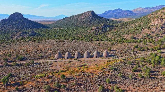 Aerial view of historic stone beehive kilns illuminated by golden sunrise light in Ward Charcoal Ovens State Historic Park Nevada