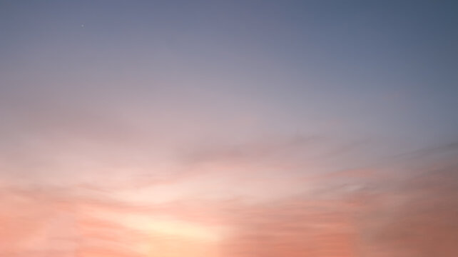At sunrise or sunset, clouds&mdash;streaked with various hues like orange and reddish-yellow&mdash;lend a dramatic quality to the sky.