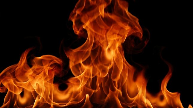 Intense roaring thermal plumes flickering against a dark void creating a dramatic warm energy display fire flames burning blaze black background abstract glow glowing bright hot heat energy light