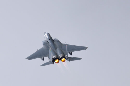 Top view of a F-15 Eagle with afterburners on, in beautiful light