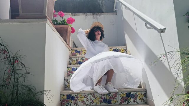 Happy Woman Relaxing on Tiled Stairs in Sunny Capri Island Italy