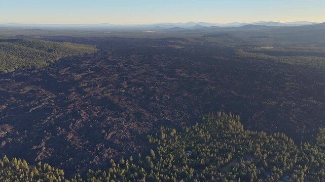 A bird's eye view of an ancient lava field shows an extremely rugged and inhospitable landscape near Bend, Oregon. This vast area is part of the volcanic Cascade Mountain Range.